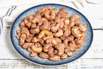 Cashew nuts on wood background. Raw cashews. Healthy food. close up