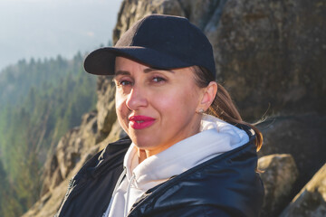 Portrait of a woman at the foot of a mountain.