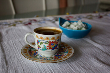 Turkish coffee in traditional cups and Turkish delights on the table