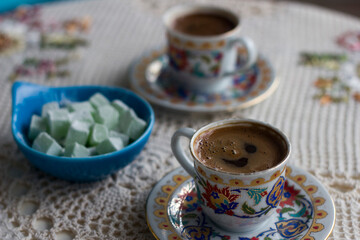 Turkish coffee in traditional cups and Turkish delights on the table