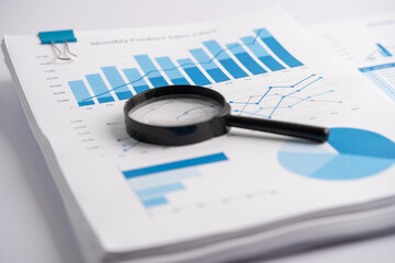 Fototapeta premium Magnifying glass on charts graphs paper. Financial development, Banking Account, Statistics, Investment Analytic research data economy, Stock exchange trading, Business office company meeting concept.