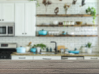 The empty table wooden board in front of the background is blurred. Brown wood perspective in the home kitchen – can be used to display or montage your products. Mock up for product display.