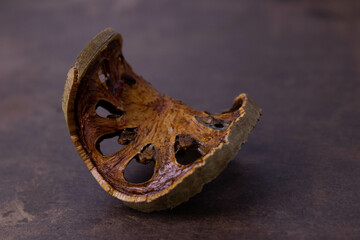 Close up a slice of dried Bael on copper background