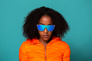 Black woman in stylish outerwear and sunglasses
