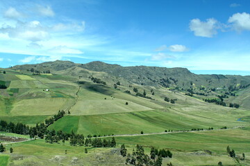 Fototapeta na wymiar Patchwork of farm fields on the slope of a mountain near Latacunga, Ecuador