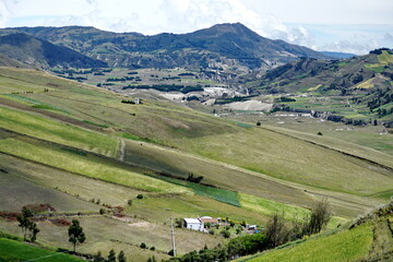 Fototapeta na wymiar Patchwork of farm fields on the slope of a mountain near Latacunga, Ecuador