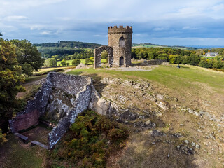 An aerial view of ruins on the hillside in front of Old John folly in Bradgate Park,...