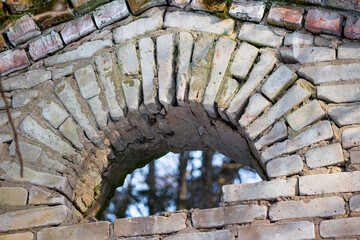 Arched masonry of sand-lime bricks in an old abandoned building close-up