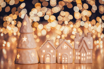 Ceramic house and christmas tree on light spotted background