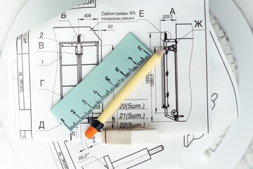 Birthday cake for an architect with floor plans. Cake for an engineer with blueprints made of edible sugar paper and fondant pencil, ruler and drawing instruments. Selective focus