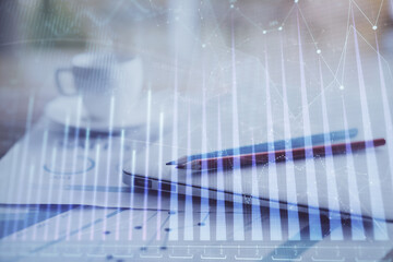 Forex graph hologram on table with computer background. Double exposure. Concept of financial markets.