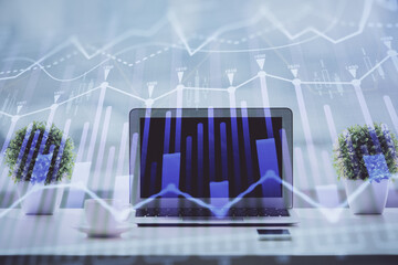 Forex graph hologram on table with computer background. Multi exposure. Concept of financial markets.