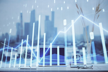 Forex graph hologram on table with computer background. Multi exposure. Concept of financial markets.