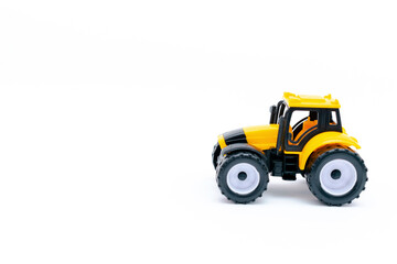 yellow plastic tractor, truck, lorry, car toy isolated, toys for children, kids development, playing