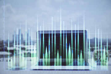 Forex graph hologram on table with computer background. Multi exposure. Concept of financial...