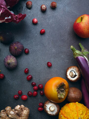 Top view winter groceries, healthy vegetarian ingredients for cooking a dinner on a dark background