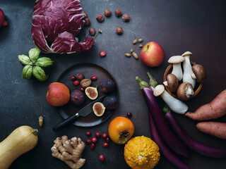 Top view winter groceries, healthy vegetarian ingredients for cooking a dinner on a dark background