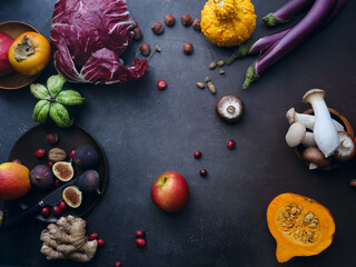 Top view winter groceries, healthy vegetarian ingredients for cooking a dinner on a dark background