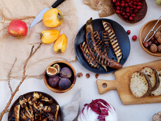 Flat lay seasonal vegetables, fruits and bread, healthy vegetarian ingredients. Grilled aubergines and mushrooms