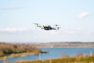 Drone in flight near lake