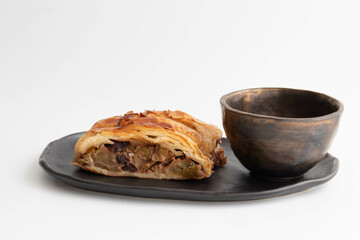 Close up Apple Strudel with a cup of tea on white background