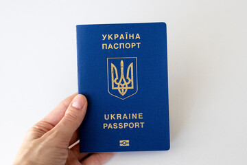 Ukrainian passport in a woman's hand on a white background