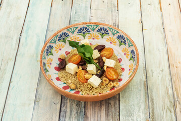 The original Greek salad is made with tomato, cucumber, bell pepper, and red onion, all seasoned with salt, black pepper, and oregano, and seasoned with olive oil