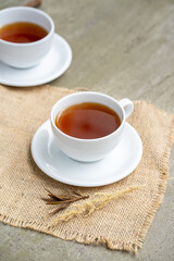Minimalist tea is served on the concrete table.