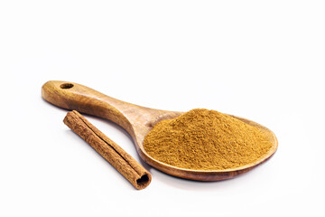 cinnamon powder with cinnamon stick in rustic wooden spoon, isolated white background and copy space