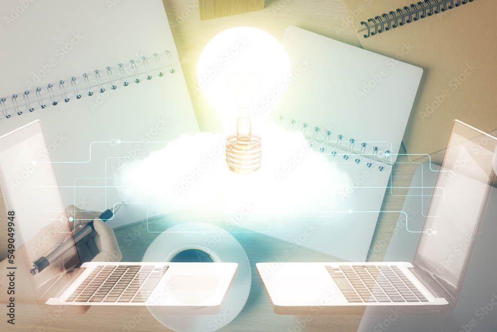 Poster bulb hologram over hands taking notes background. concept of idea. double exposure