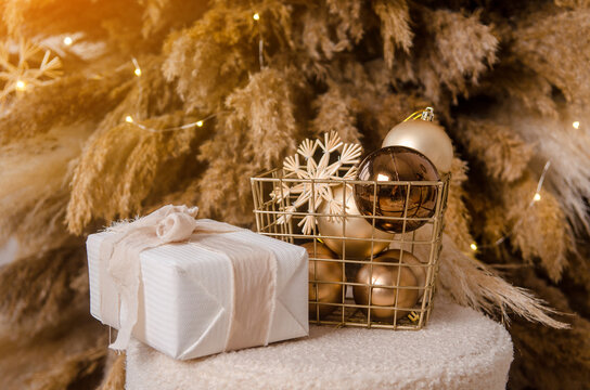 New Year picture for card or greeting. Pampas grass brown Christmas tree, white gift boxes, round toys and garland light