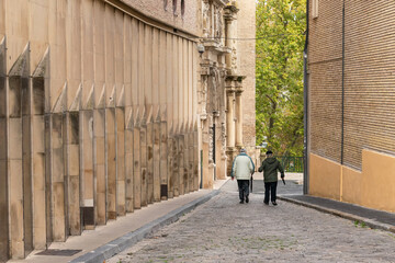 Two men passing and chatting in the Old Town of Pamplona