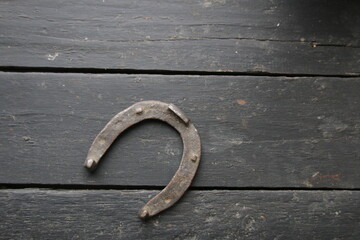 An old horseshoe on a vintage table. Retro style.