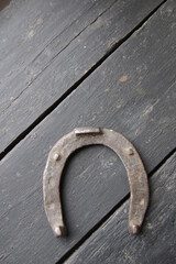 An old horseshoe on a vintage table. Retro style.