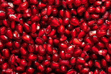 Ripe pomegranate grains. Fruit red background. High quality photo