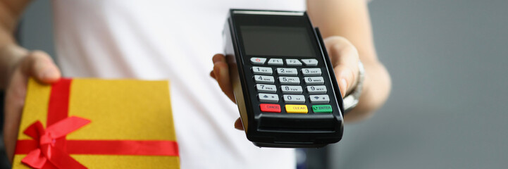 Man courier give credit card reader machine for cashless payment, delivery box with present