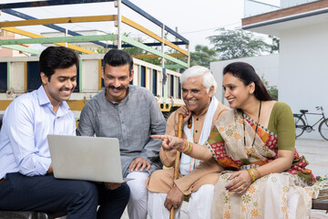 Naklejka premium Indian family meeting financial advisor at village.