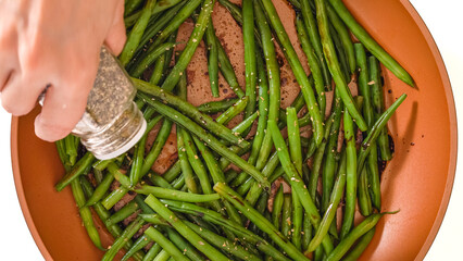 Pan fried French green beans (Haricots Verts) recipe. String beans on a frying pan with soy sauce,...