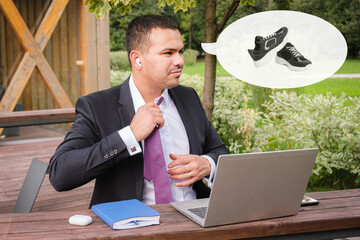 Serious young man in business suit takes off his tie after finishing work on open veranda. Man thinks about sports after the end of the working day. End of the working week.