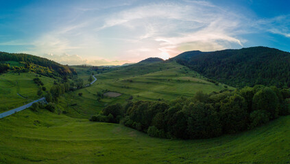 Fototapeta na wymiar Winding track is like slopes of Rhodope Mountains with forests. Panorama, top view