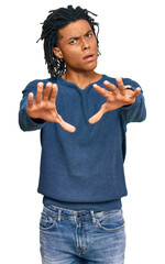 Young african american man wearing casual winter sweater doing stop gesture with hands palms, angry...