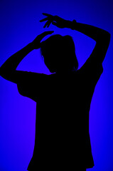 Fototapeta na wymiar Silhouette of a girl on a blue background. 