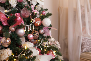 Christmas, New Year interior with pink and white fur-tree, fir tree decoration with balls and flowers