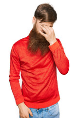 Redhead man with long beard wearing casual clothes tired rubbing nose and eyes feeling fatigue and headache. stress and frustration concept.
