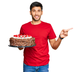 Young handsome man celebrating birthday with cake smiling happy pointing with hand and finger to the side