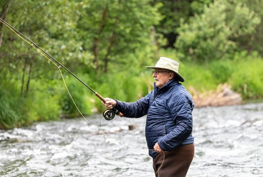 Rear closeup of a man enjoying fishing on Monnow Valley Fishery
