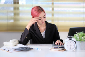 Stressed-out businessman sits at his desk at work. Businesswoman who is tired and overworked, Young, stressed-out