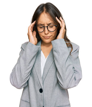 Young brunette woman wearing business clothes with hand on head for pain in head because stress. suffering migraine.