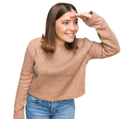 Young beautiful woman wearing casual clothes very happy and smiling looking far away with hand over head. searching concept.