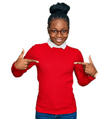 Young african american woman wearing casual clothes and glasses looking confident with smile on face, pointing oneself with fingers proud and happy.